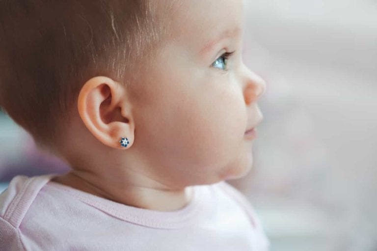 infant with ear piercing